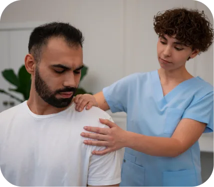 Healthcare professional performing shoulder exam on male patient to assess AC joint pain and inflammation