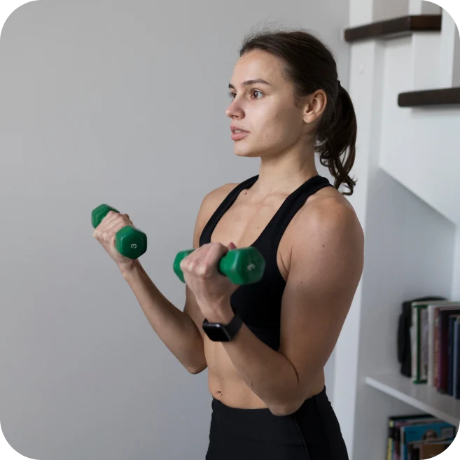 woman lifting dumbbells with potential biceps tendon strain affecting the shoulder