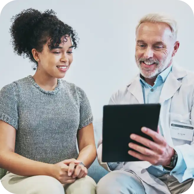 orthopedic doctor reviewing shoulder cartilage or bone injury results with patient on digital tablet