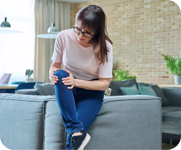 Woman holding her knee in pain due to a meniscus tear — illustration for an article explaining meniscus repair techniques, including circumferential compression stitch, all-inside anchors, and inside-out sutures.