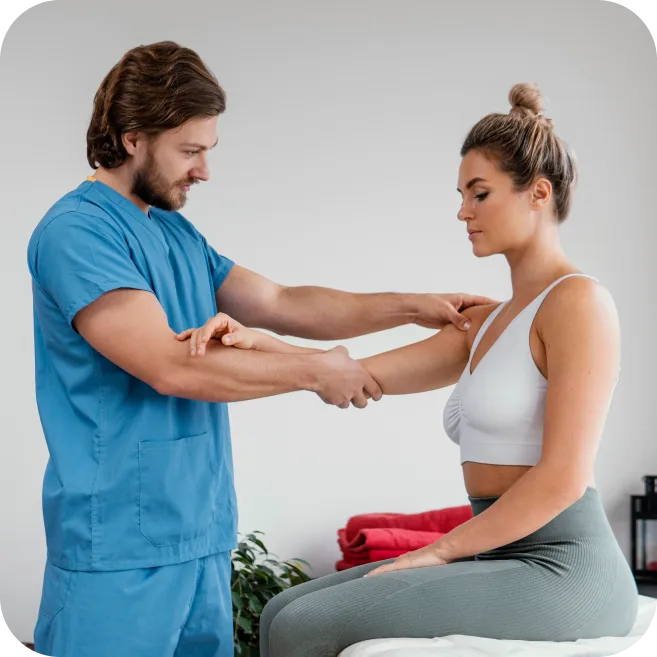 therapist assessing shoulder mobility in patient with frozen shoulder or adhesive capsulitis