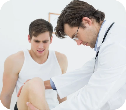 Doctor evaluating a patient’s knee during examination for suspected meniscus root tear and joint instability