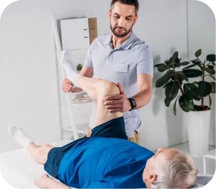 Orthopedic specialist assessing an older adult’s knee during a physical therapy evaluation for medial compartment chondromalacia