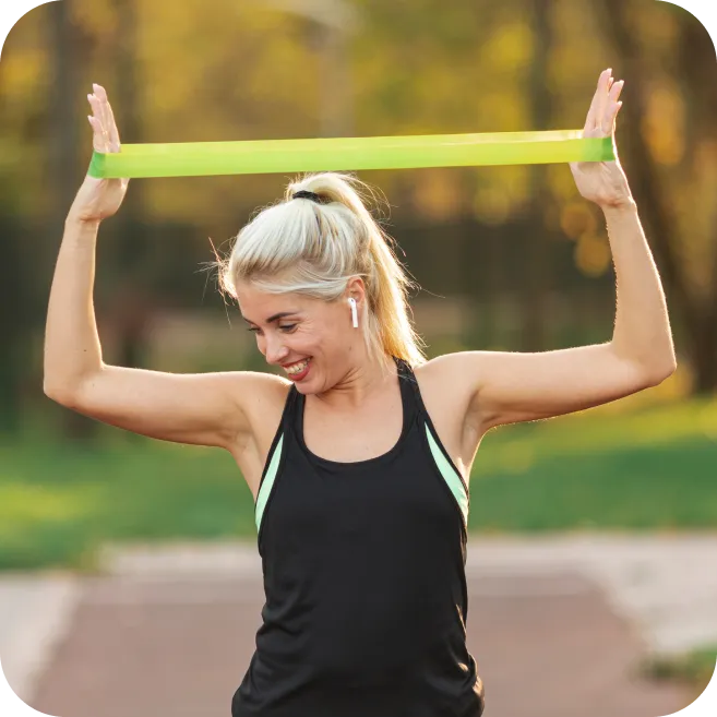 woman performing shoulder resistance band exercise to prevent rotator cuff tendon injuries