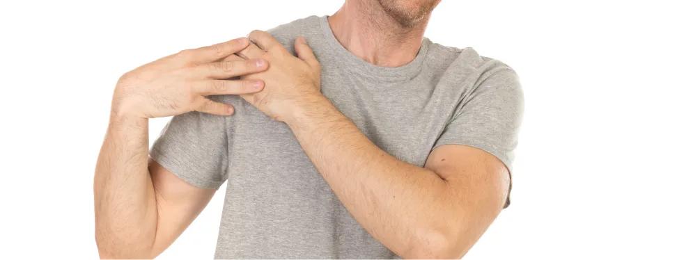 Man holding his shoulder due to AC joint pain, illustrating symptoms of degenerative AC joint disease and inflammation